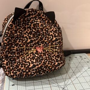 Kitty backpack leopard print black leather straps and zipper pull